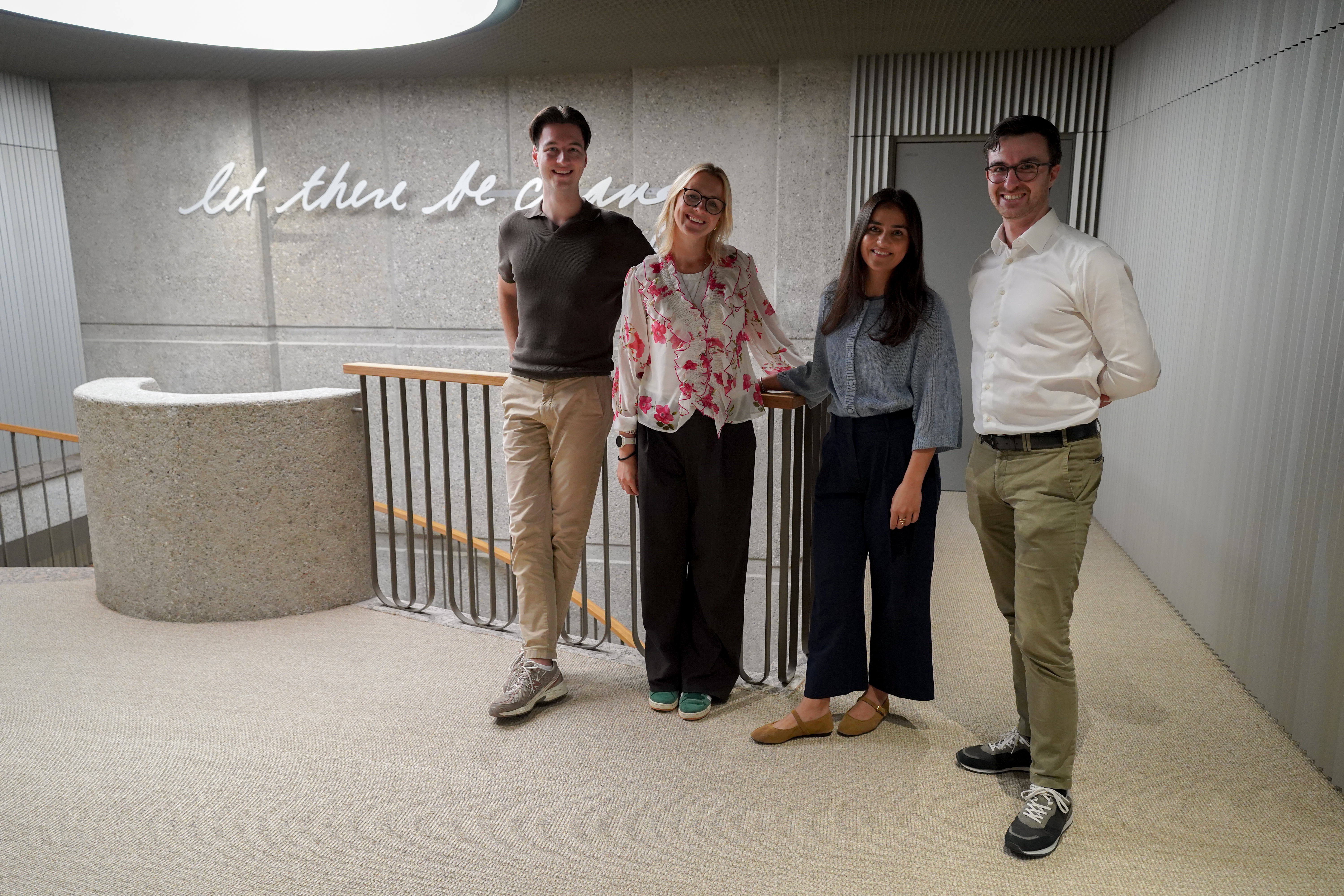 Teams pausing for a quick photo moment between meetings.